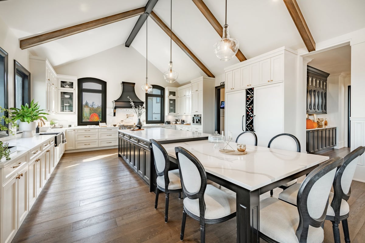 Huge modern farmhouse kitchen with dark wood cabinets, white granite countertops, and stainless appliances